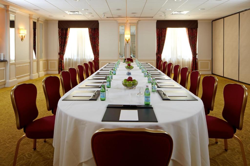 a conference room with a long table and chairs at Warwick New York in New York