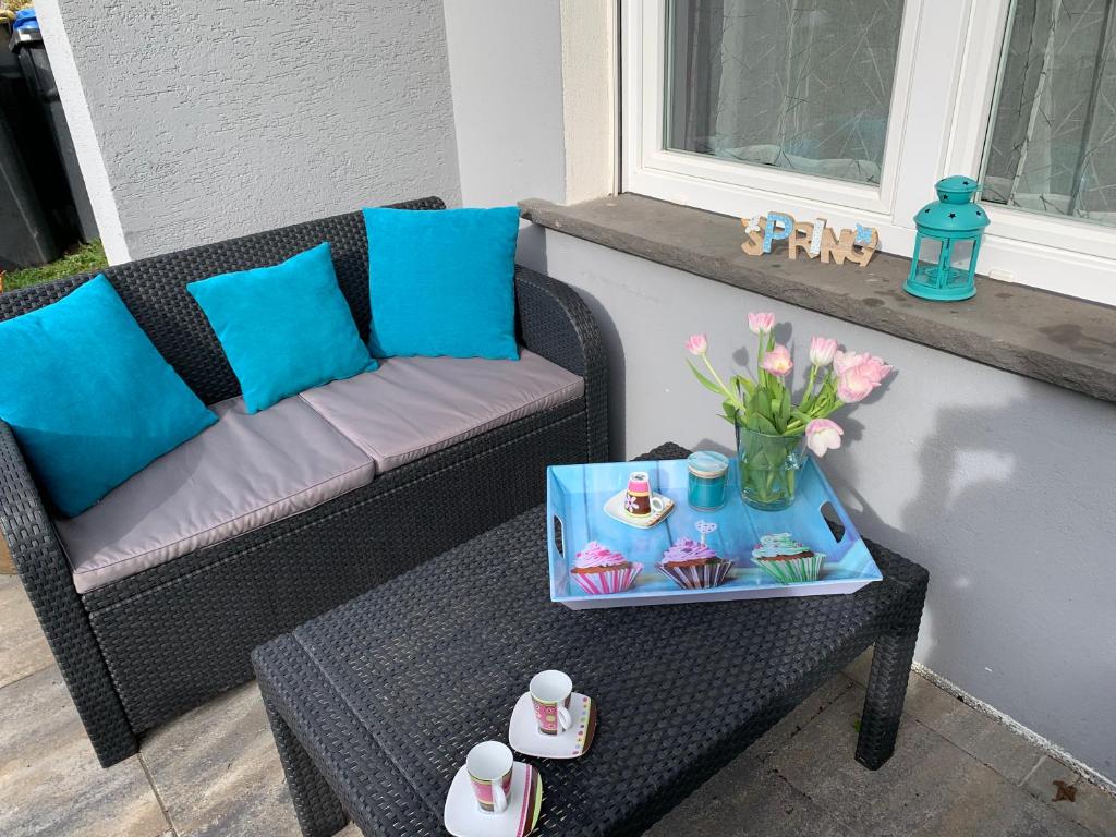 a chair and a table with a tray of cupcakes on a porch at Ferienwohnung Pomaria - 4 Sterne zertifiziert in Pommern