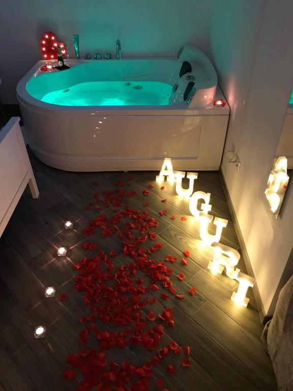 a bathroom with a tub filled with red roses at Sea fly guest house in Fiumicino
