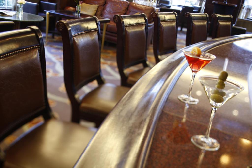 two martini glasses sitting on a table in a restaurant at Warwick New York in New York