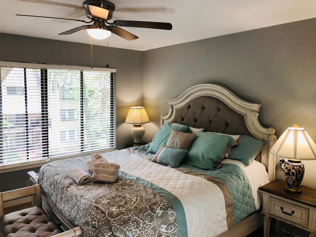 a bedroom with a large bed and a ceiling fan at Springwood Villas with pool excess half a mile from beach in Hilton Head Island