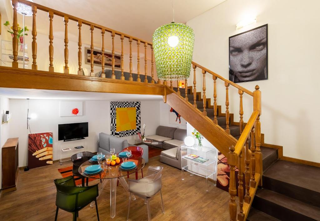 a living room with a staircase and a table at Rotonda 23 - Loft in Pantheon in Rome