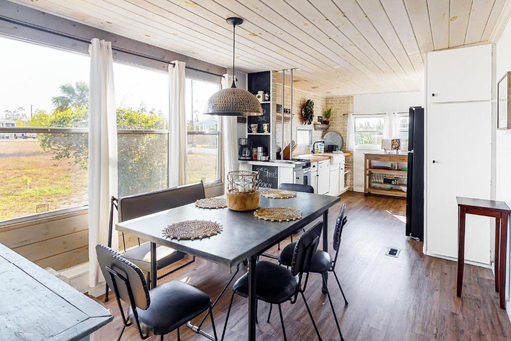 a kitchen with a table and chairs in a room at 3rd Street Beach Retreat in Mexico Beach