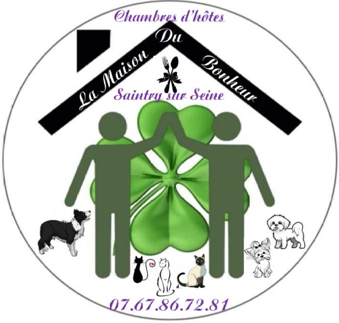 a sticker with two people and dogs on it at La Maison Du Bonheur in Saintry-sur-Seine