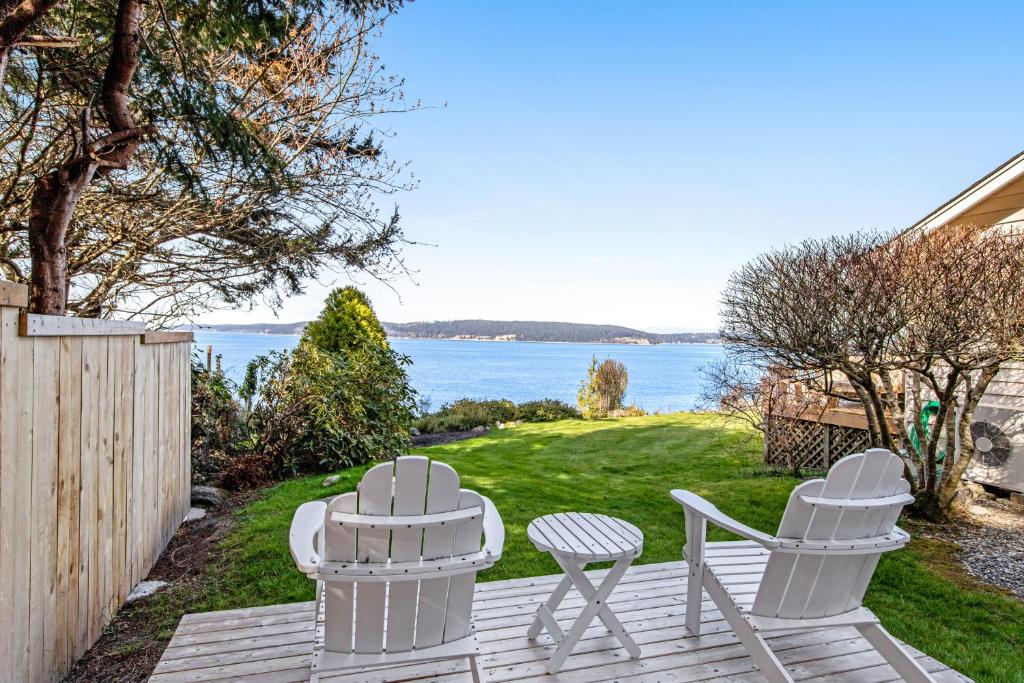 d'une terrasse avec deux chaises et une vue sur l'eau. dans l'établissement Cozy Cottage by the Sea, à Langley