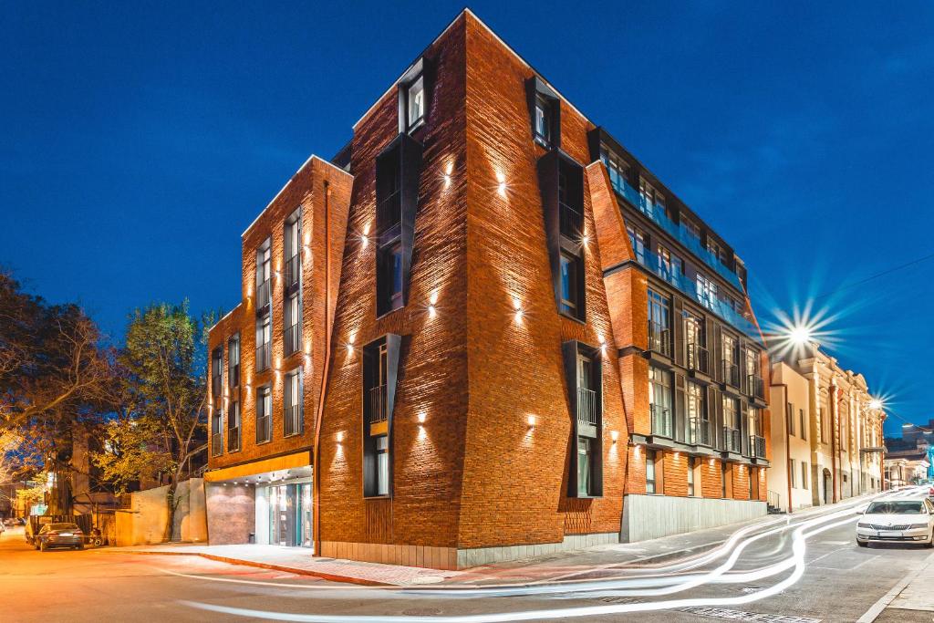 a red brick building on a city street at Taberne Boutique Hotel Tbilisi in Tbilisi City