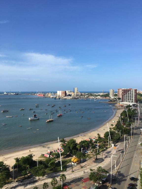 a view of a beach with boats in the water at Iracema Residence Flat - Apto Particular in Fortaleza