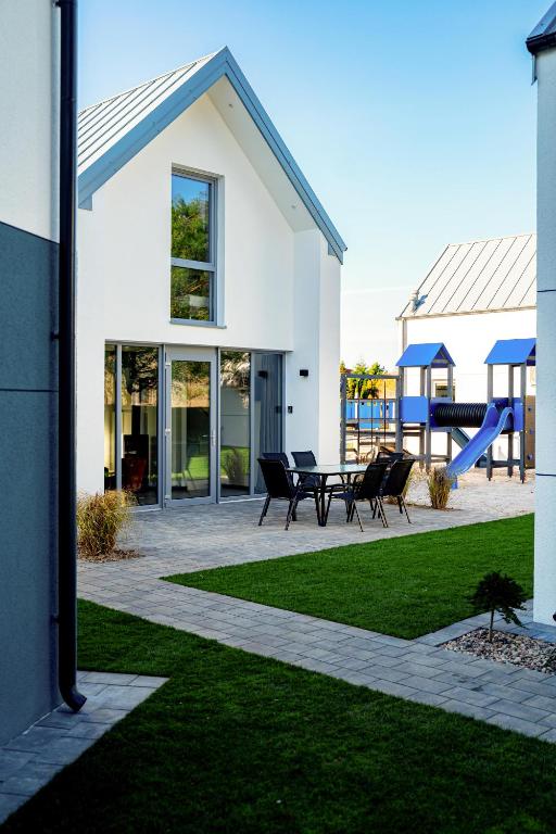 a house with a patio and a playground at Dream-House in Kopalino