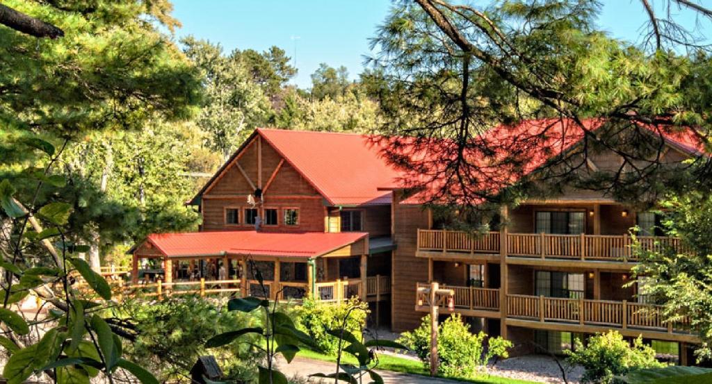 a resort building with trees in the background at Meadowbrook Resort in Wisconsin Dells