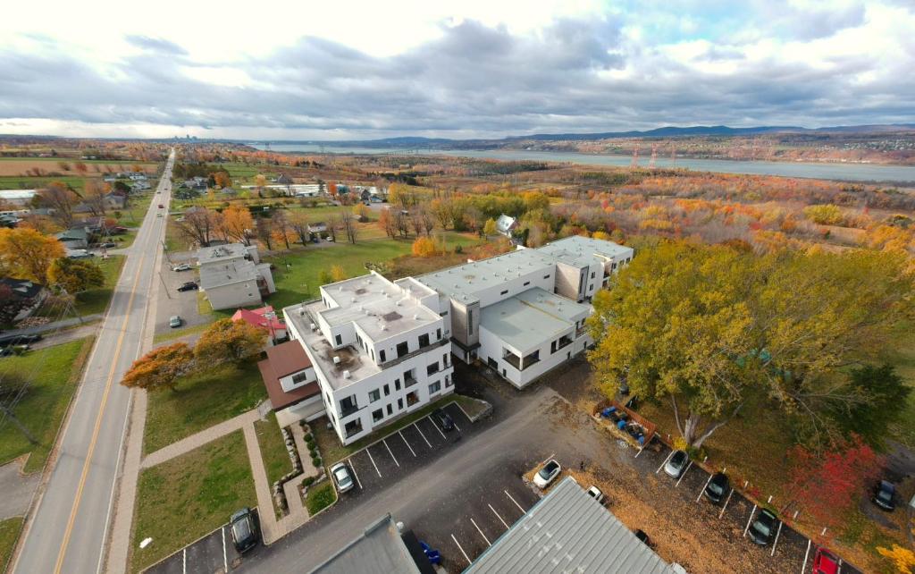 an aerial view of a white building on a street at L'île-Do - Ile d'Orléans in St-Pierre-de-l'Île-d'Orléans