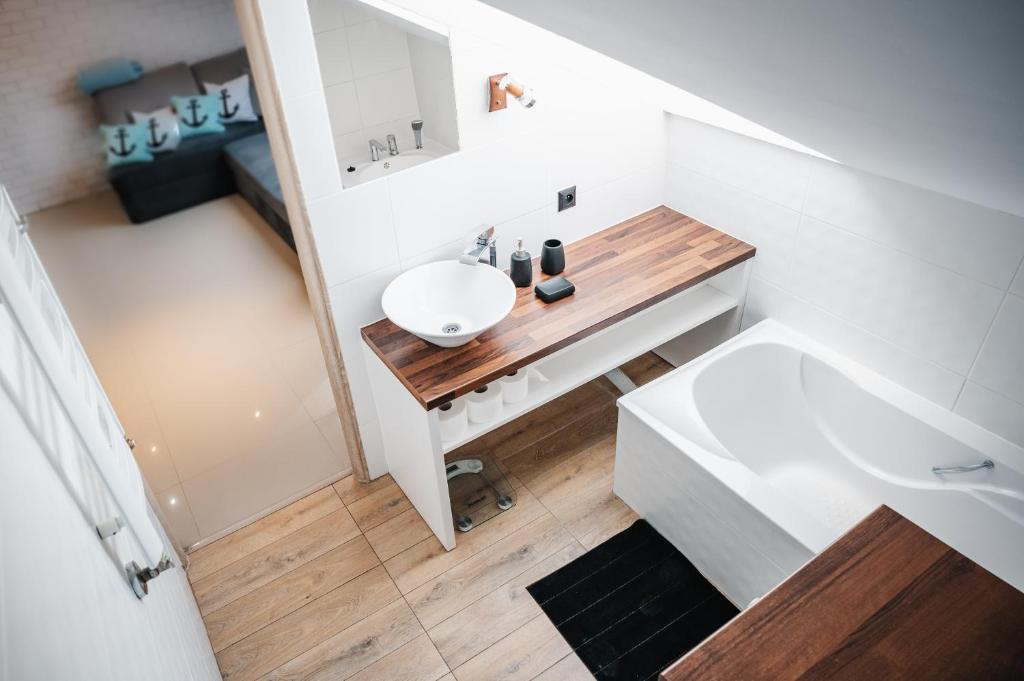 małą łazienkę z umywalką i lustrem. w obiekcie Apartament Kotwica w mieście Giżycko