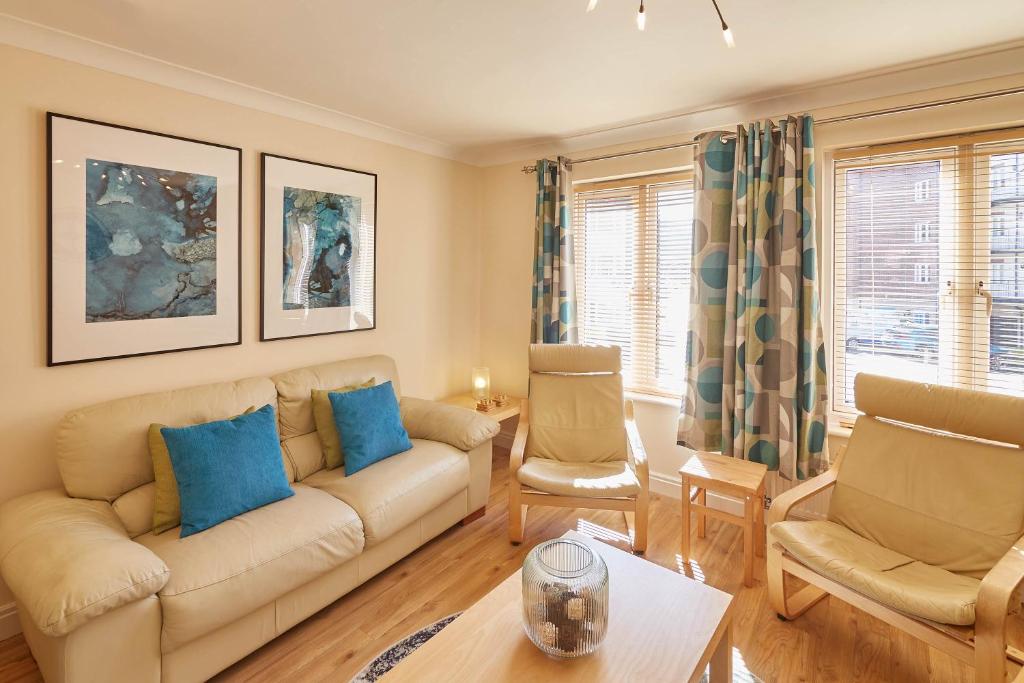 a living room with a couch and two chairs at Host & Stay - The Scuttlebutt Townhouse in Whitby