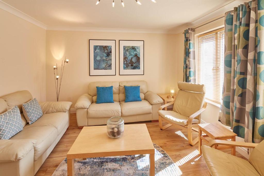 a living room with a couch and a table at Host & Stay - The Scuttlebutt Townhouse in Whitby