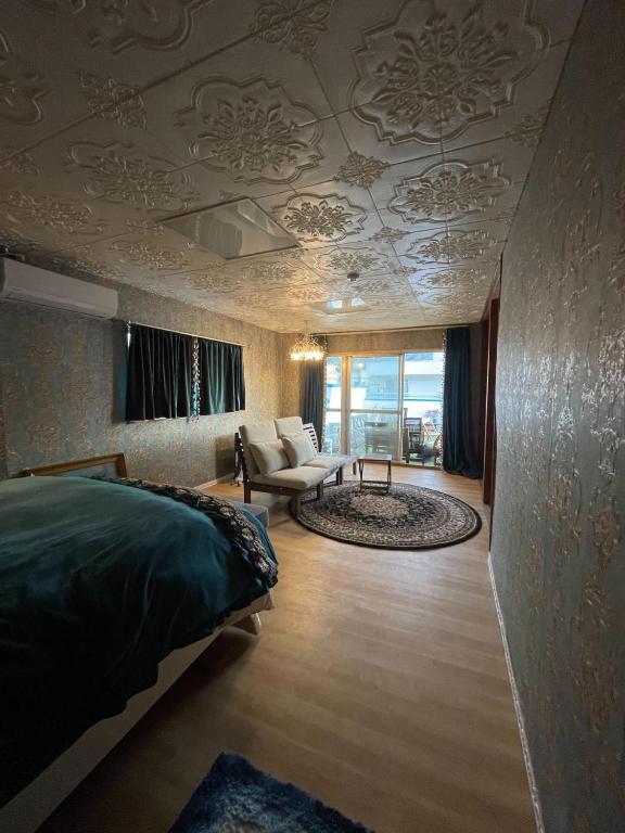 a bedroom with a bed and a living room at Ryokan La Luna in Ukusu
