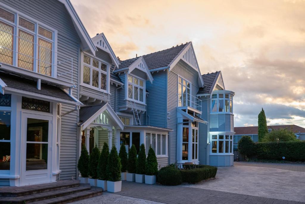 a row of houses with blue siding at Eliza's Manor in Christchurch