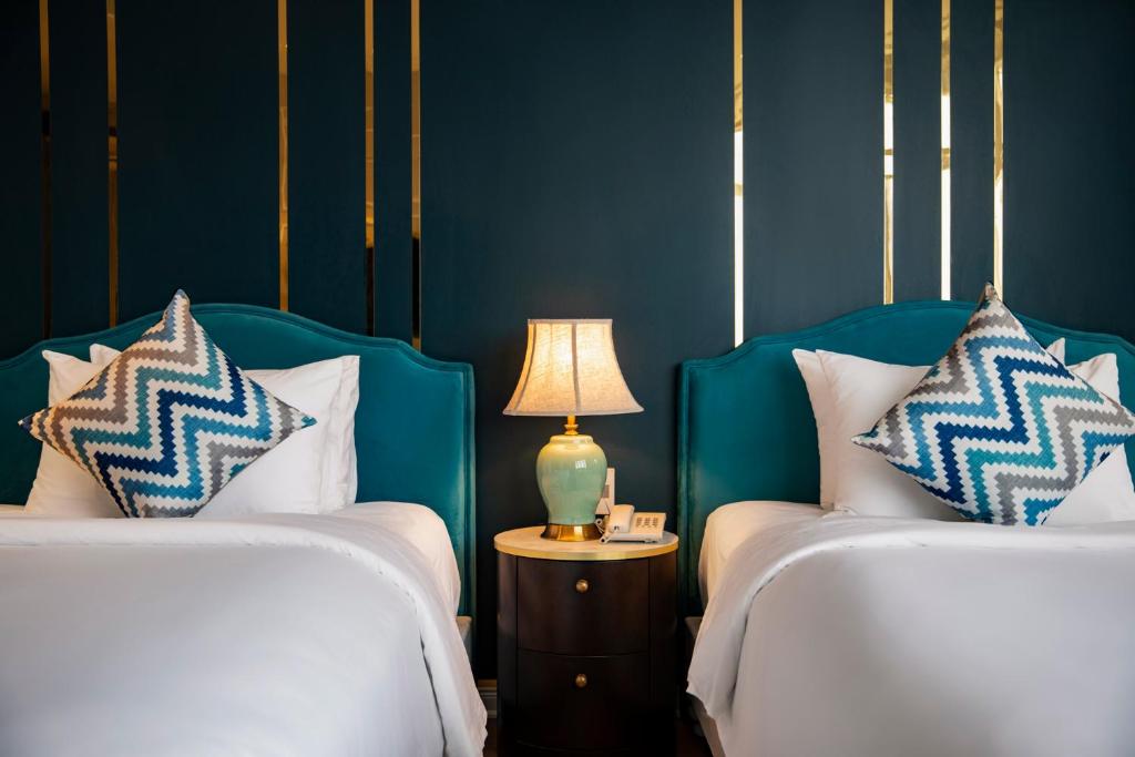 Postel nebo postele na pokoji v ubytování Angel Hotels Beach Danang