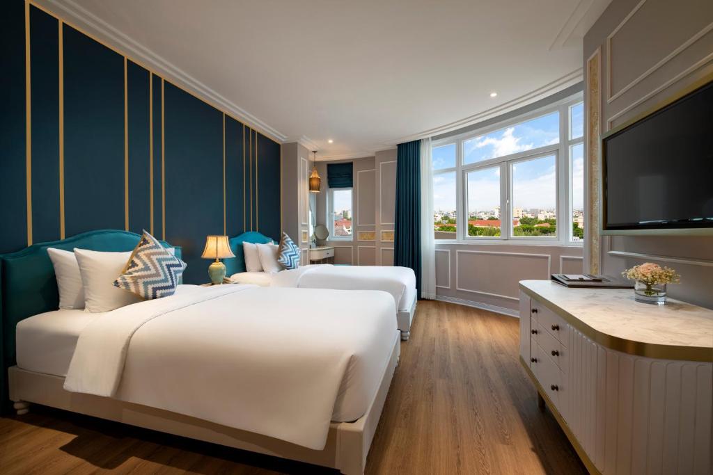 Postel nebo postele na pokoji v ubytování Angel Hotels Beach Danang