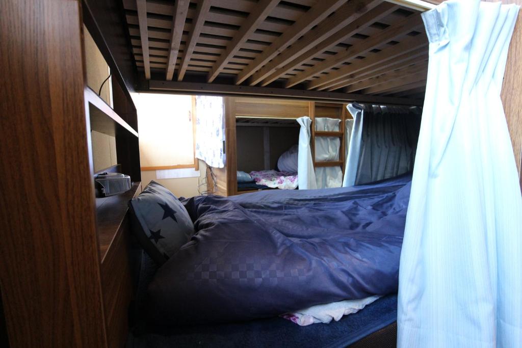 Postel nebo postele na pokoji v ubytování TOMI in Shimoda