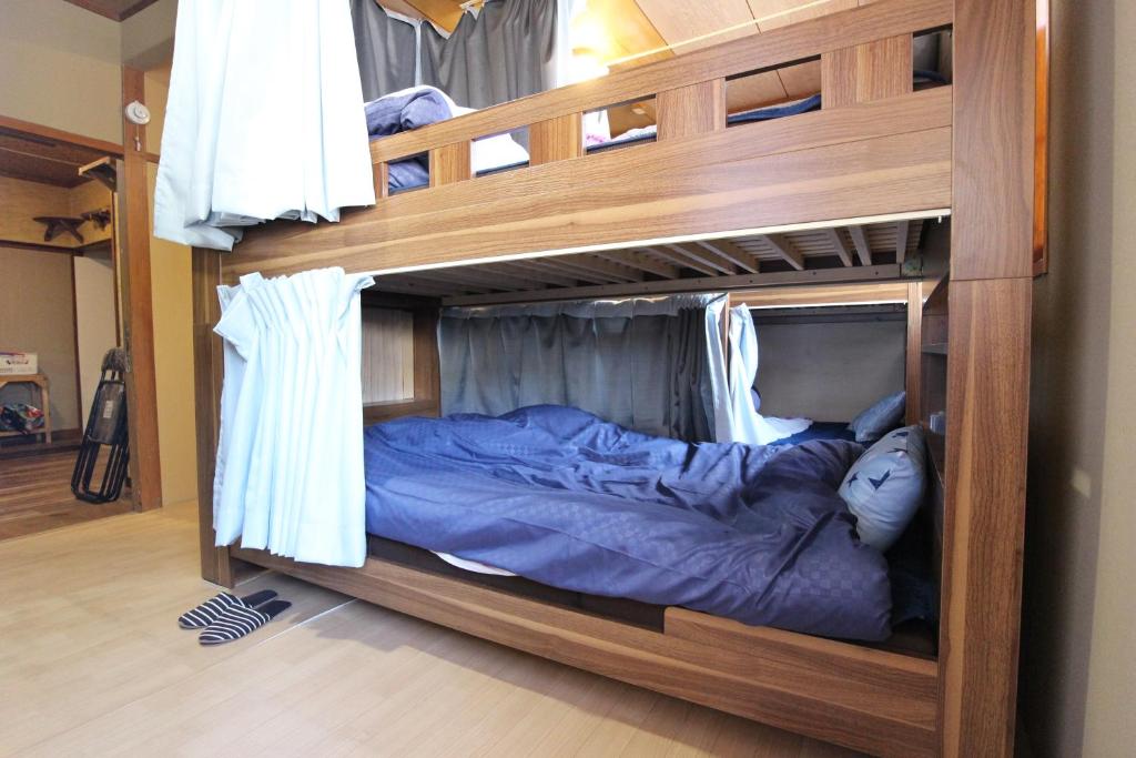 Postel nebo postele na pokoji v ubytování TOMI in Shimoda