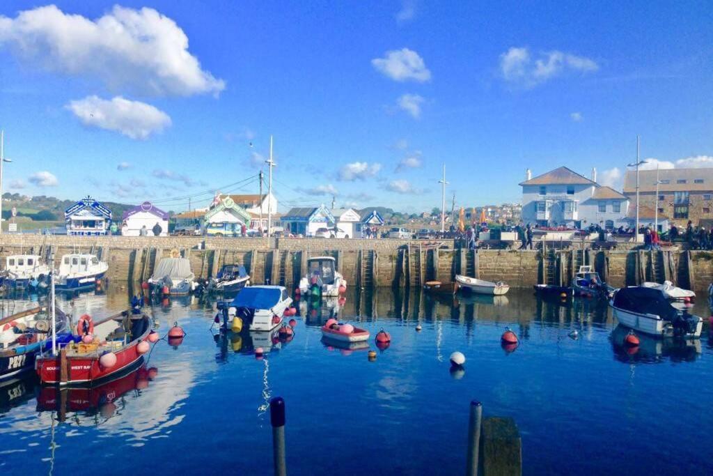 a group of boats are docked in a harbor at Entire Ground Floor Apartment - West Bay in West Bay