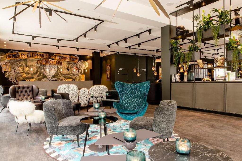 a large room with a large table and chairs at Motel One Paris-Porte Dorée in Paris