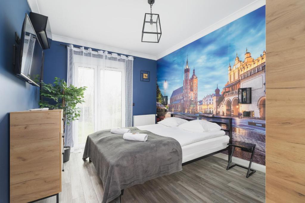 a bedroom with a large bed with a view of a city at Lema Apartment near Tauron Arena by Renters Prestige in Krakow
