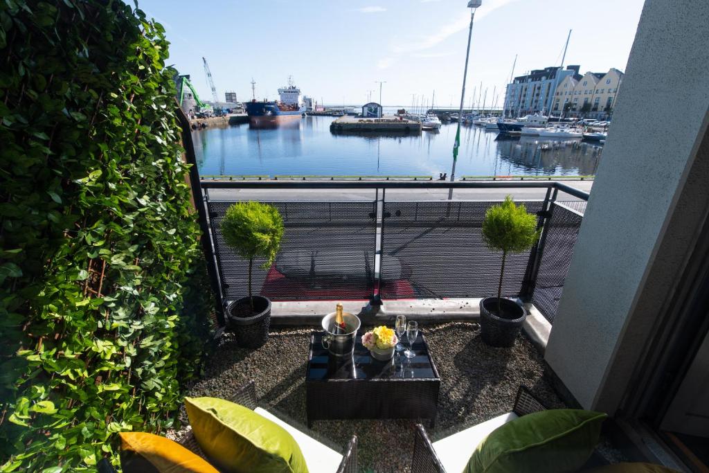 a view of a marina from a balcony with plants at Sea View Luxury City Centre - Best Location in Galway