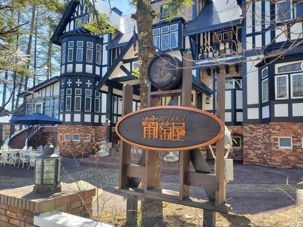 a playground in front of a building with a clock at プチホテル葡萄屋 in Hakuba
