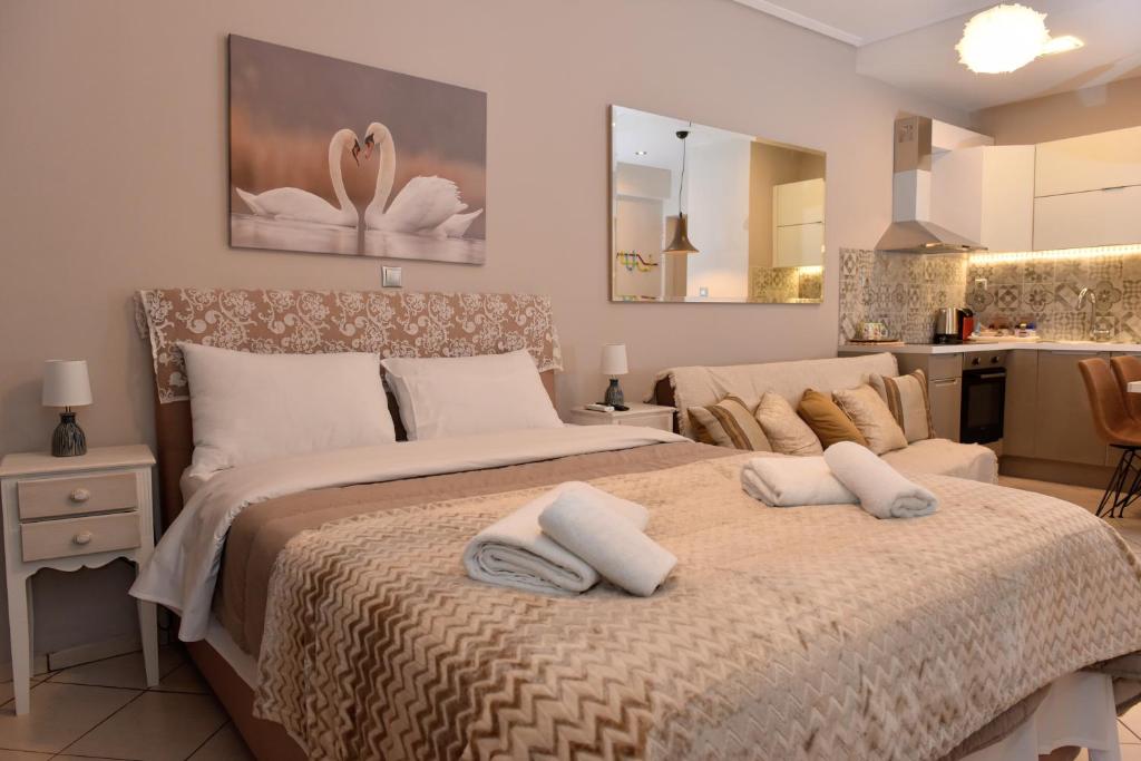 a bedroom with a large bed with two pillows on it at Cozy Luxury Apartment in the Heart of Athens 8-2 in Athens