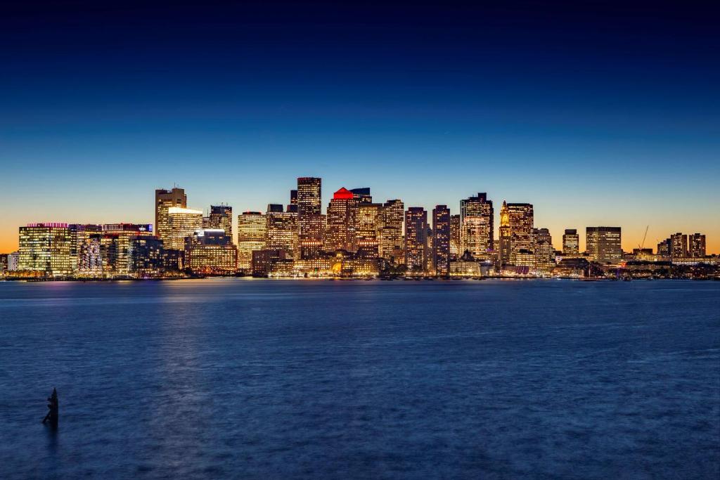 a view of a city from the water at sunset at Hyatt Regency Boston Harbor in Boston