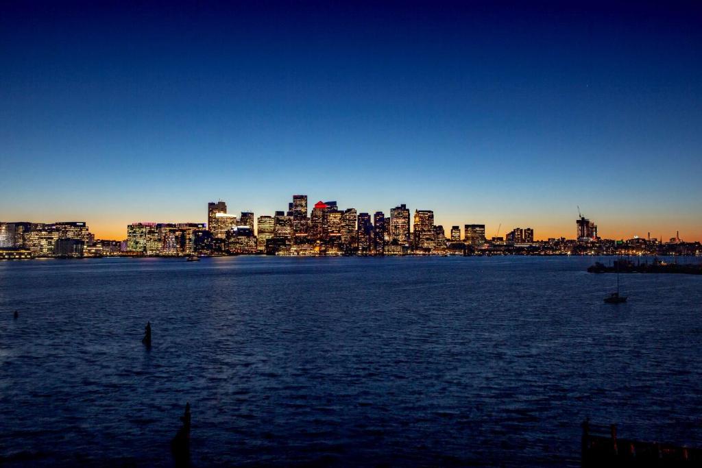 a view of a city from the water at sunset at Hyatt Regency Boston Harbor in Boston