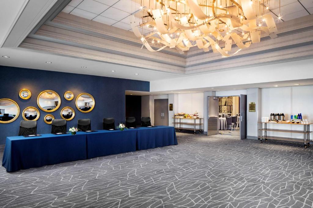 a lobby with a blue table and a chandelier at Hyatt Regency Boston Harbor in Boston