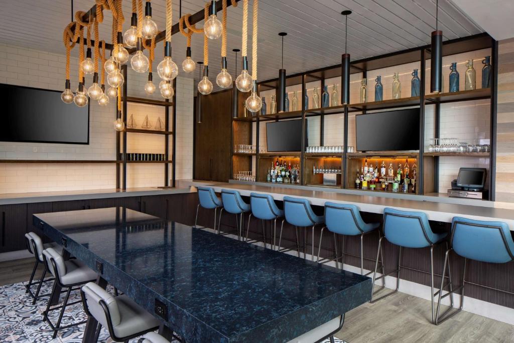 a bar with a black table and blue chairs at Hyatt Regency Boston Harbor in Boston