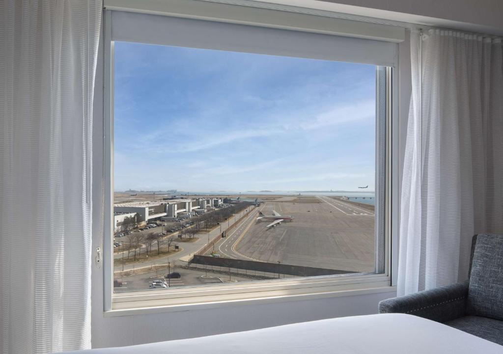a large window in a hotel room looking out at an airport at Hyatt Regency Boston Harbor in Boston