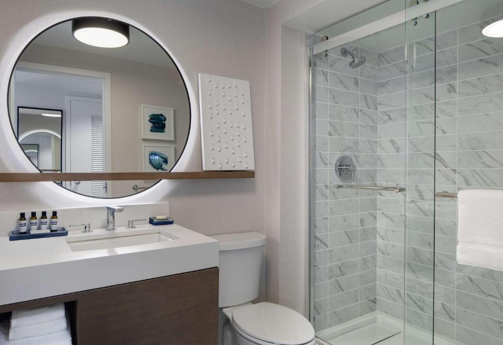 a bathroom with a shower and a toilet and a sink at Hyatt Regency Boston Harbor in Boston
