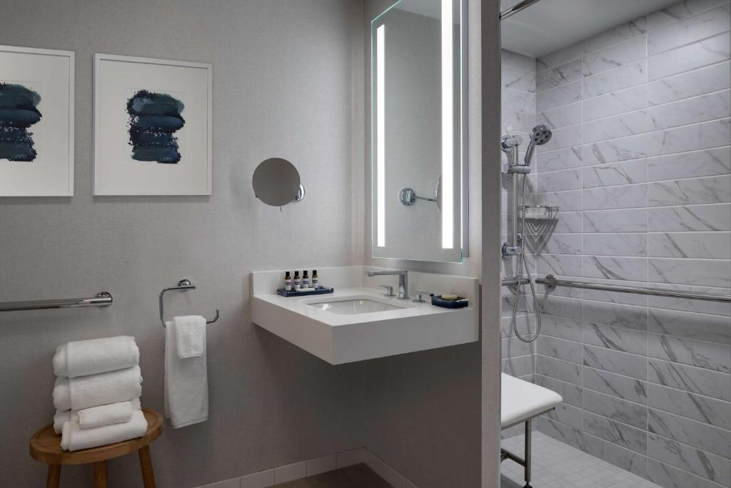 a white bathroom with a sink and a shower at Hyatt Regency Boston Harbor in Boston