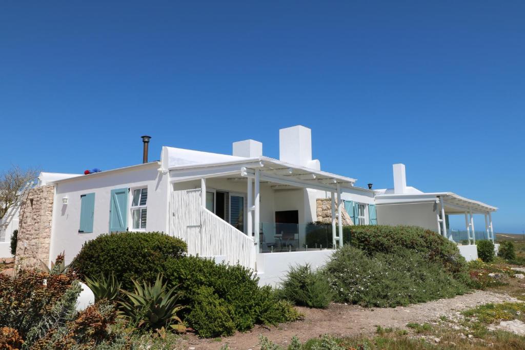 a white house on the beach at Dune Ridge Cottage in Paternoster