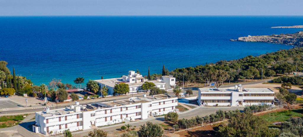 an aerial view of a large white building next to the ocean at Konnos Bay Gardens in Protaras