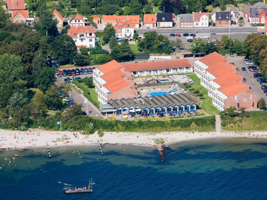 an aerial view of a resort on a beach at 4 person holiday home on a holiday park in Faaborg in Fåborg