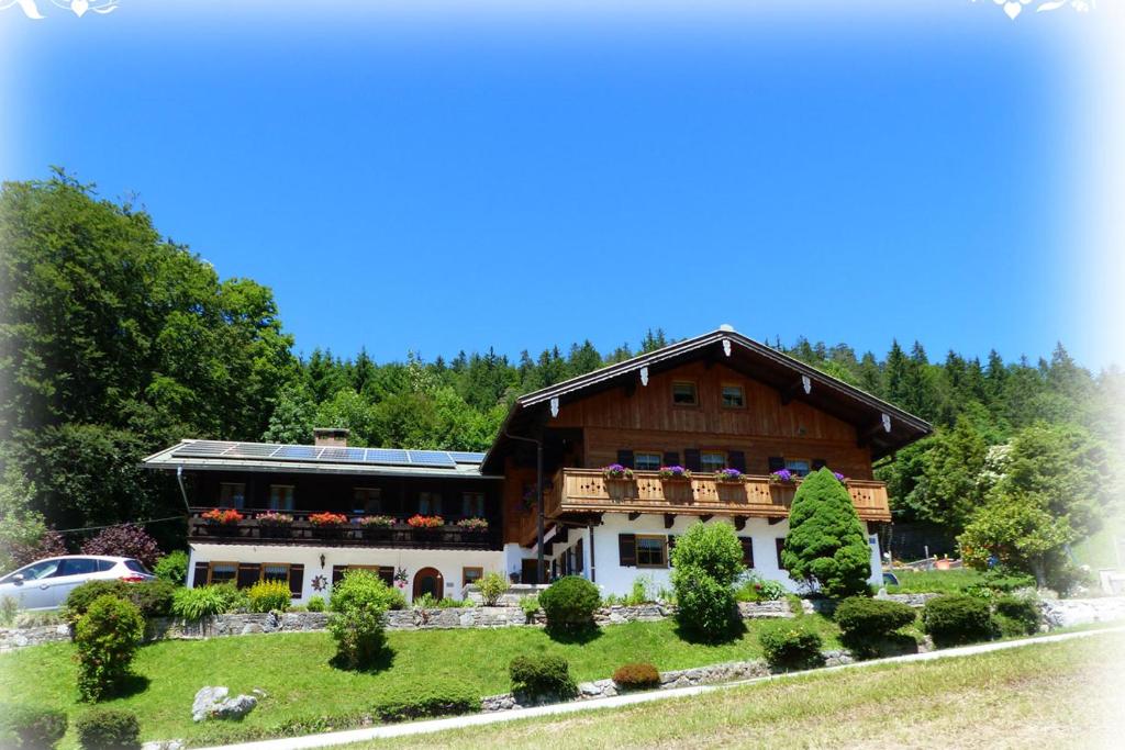 a large wooden house with a car parked in front of it at Haus Tauernblick in Berchtesgaden