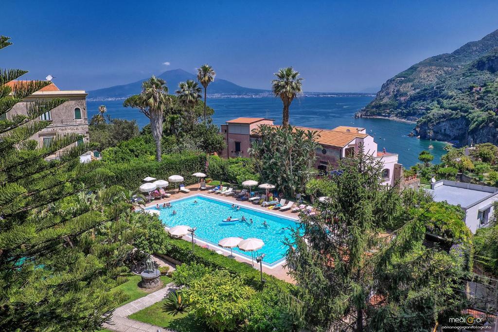 a resort with a swimming pool next to the ocean at Aequa Hotel in Vico Equense