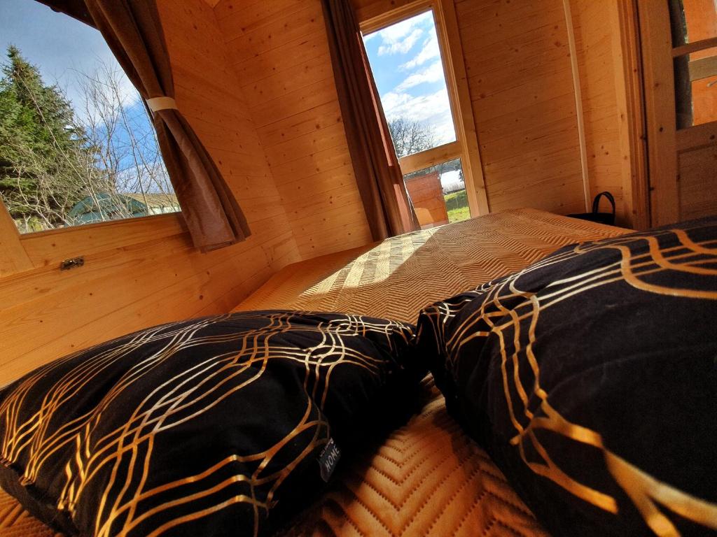 a bedroom with a bed in a room with a window at Domki nad jeziorem w Burdągu in Jedwabno