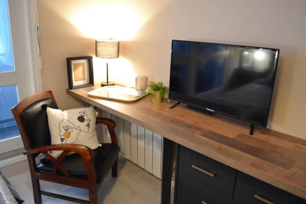 a large flat screen tv sitting on top of a table at Studio 24 - Coucher de Soleil & Vue Mer in Courseulles-sur-Mer