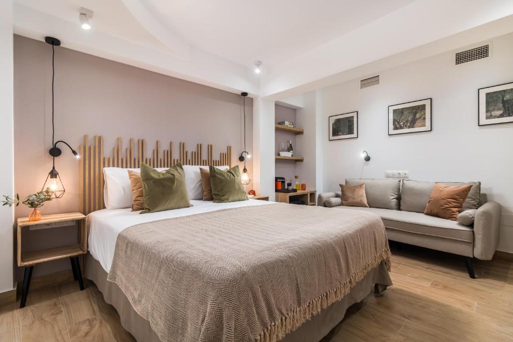 a bedroom with a large bed and a couch at Linda Boutique Hotel in Marbella