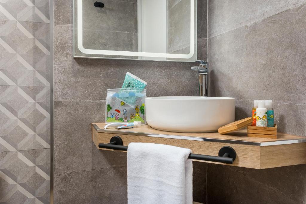 a bathroom with a sink and a mirror at Linda Boutique Hotel in Marbella
