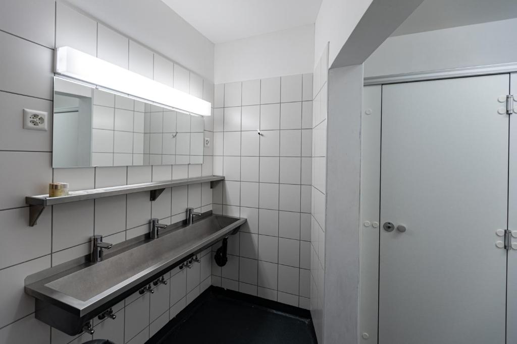 a bathroom with a sink and a mirror at Hotel Restaurant Stockalperturm in Ruden