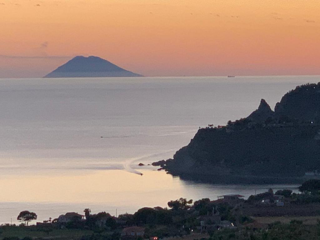 a view of a mountain in the ocean at sunset at Miriasol Bed and Breakfast in Capo Vaticano