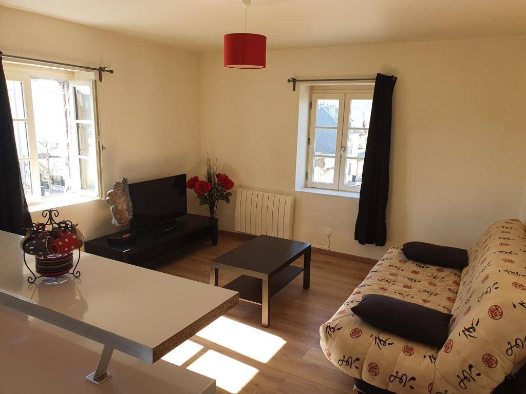 a living room with a couch and a table at Appartement en plein centre de Deauville 2éme in Deauville