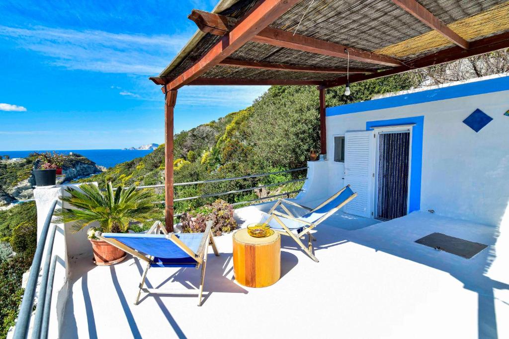 a balcony with chairs and a view of the ocean at SOLEMAREPONZA Casa Bougainvillea in Ponza