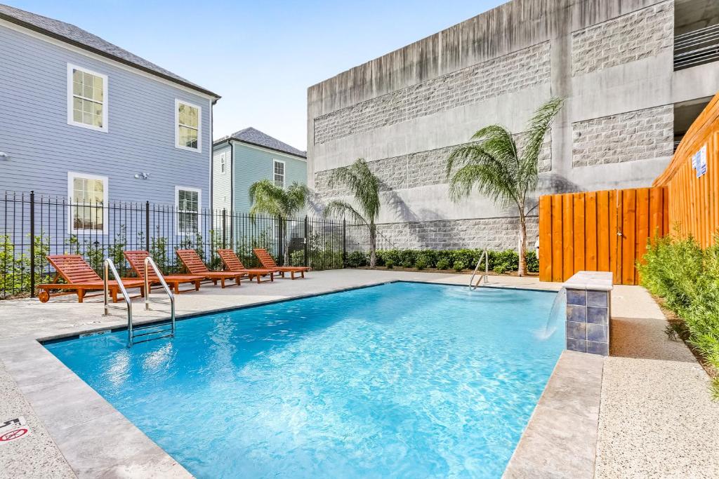 a swimming pool in the backyard of a house at Hosteeva Modern Condo Near Magazine St & Close to FQ in New Orleans